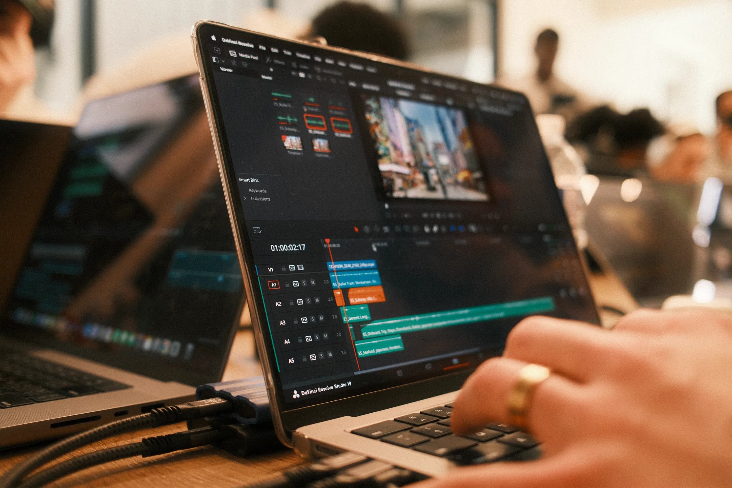 Creator editing in DaVinci Resolve at the retreat long table